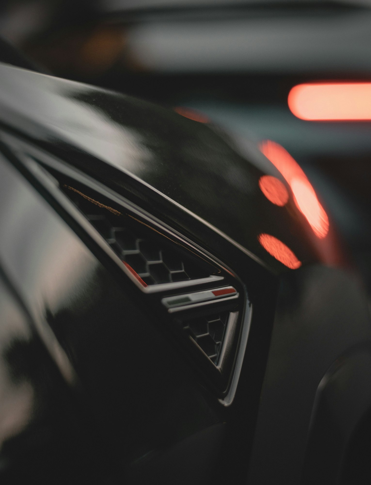 Vertical closeup of the luxury black car details