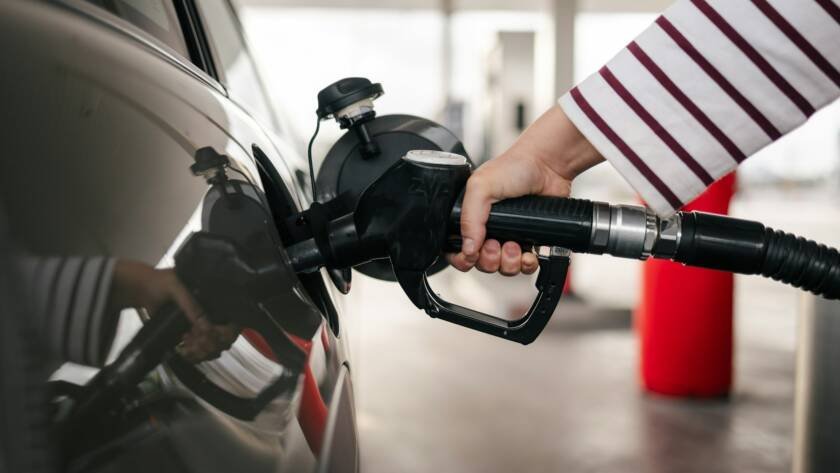 Young person filling up the car with gasoline